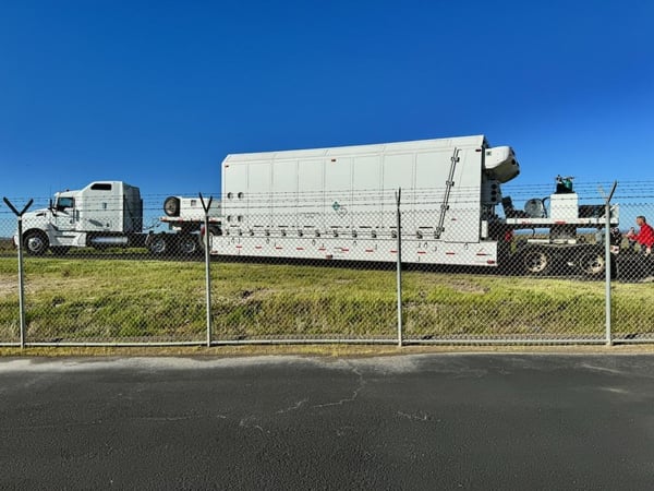 Specialized trailer transporting oversized medical equipment.