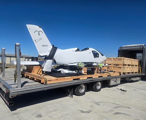 airplane body on flatbed truck