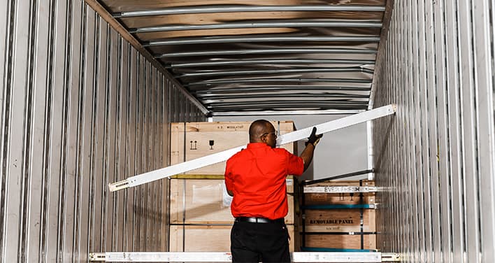 white-glove team member prepping crate for final delivery