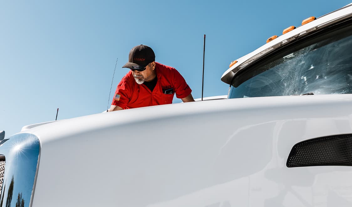 close-up of Legacy team member cleaning fleet truck