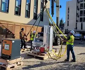Rigging team positioning oversized equipment safely