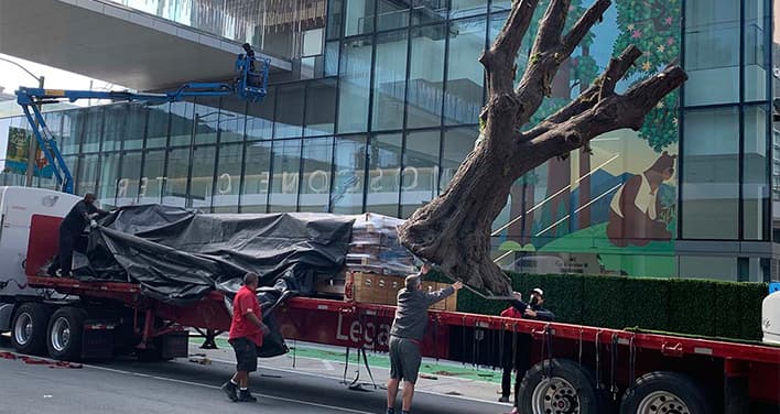 moving tree-shaped trade show component off flatbed