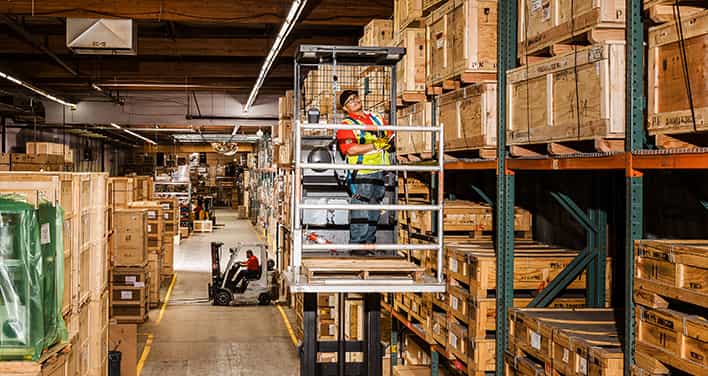 man on lift inside warehouse