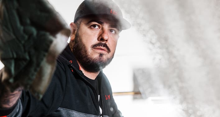 man washing truck window