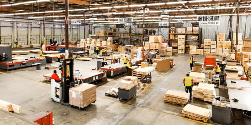 Workers coordinate freight packaging in a logistics facility.