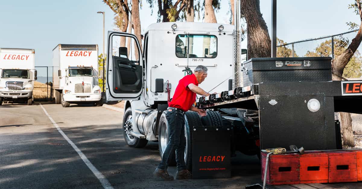Legacy driver preparing specialized shipment using company-owned truck and equipment