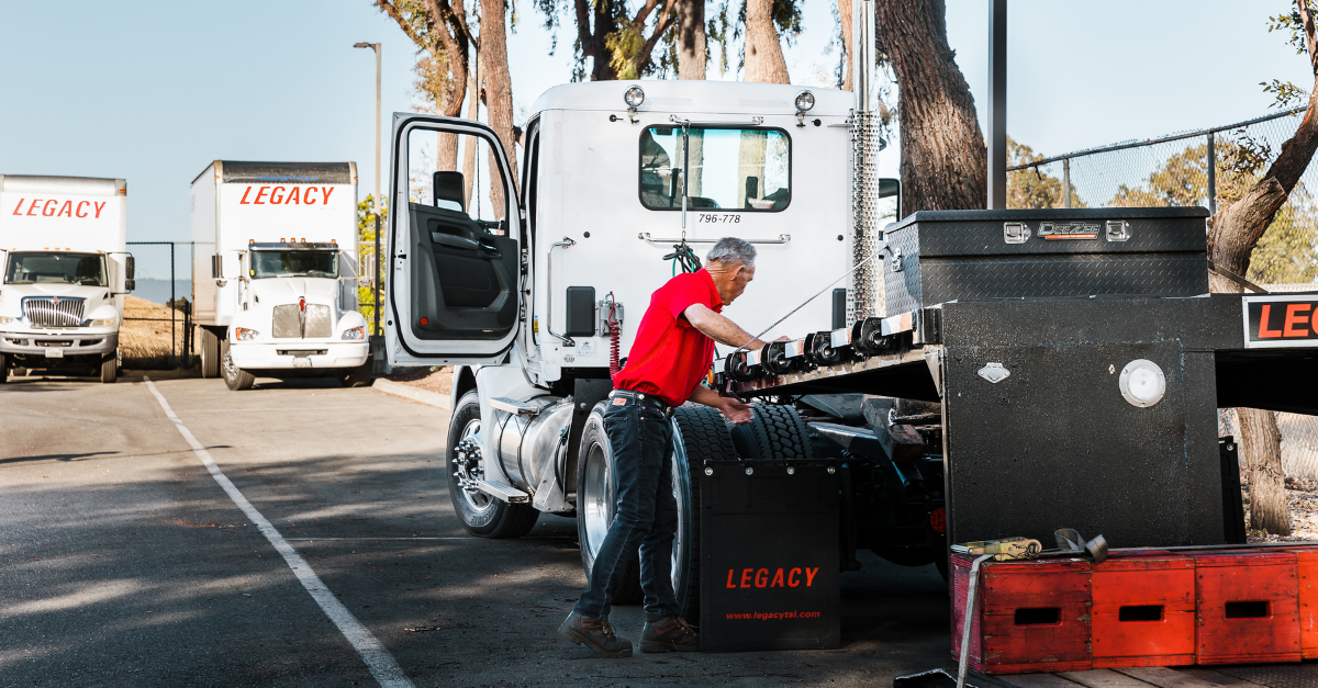 Legacy driver preparing specialized shipment using company-owned truck and equipment