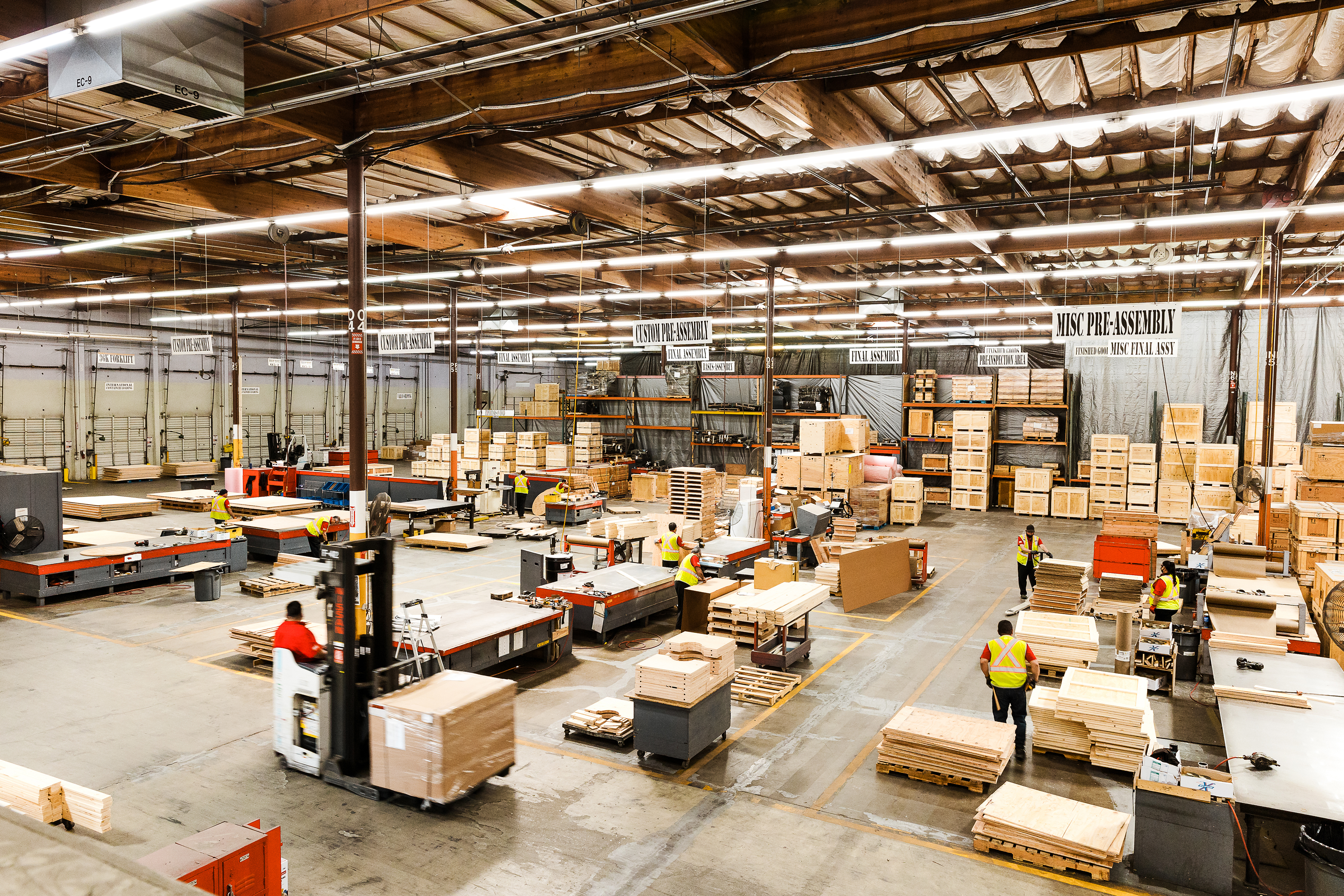 Workers coordinate freight packaging in a logistics facility.