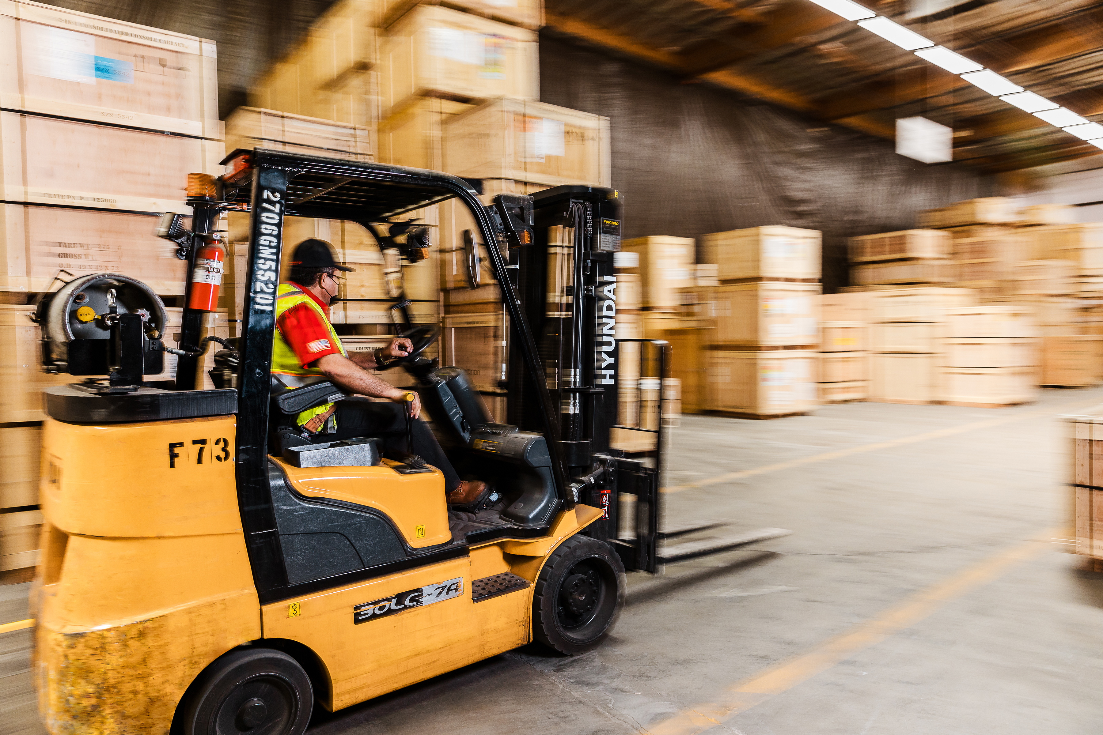 Warehouse worker operating a forklift in a Legacy logistics facility.