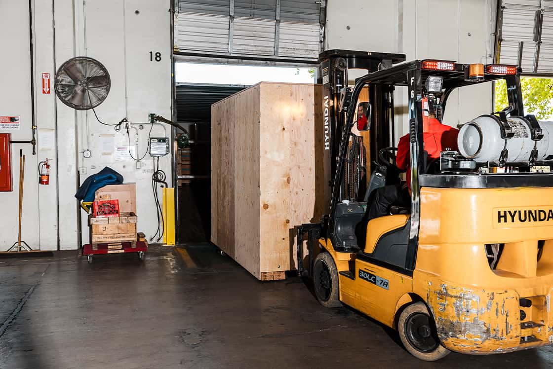 loading large crate onto trailer