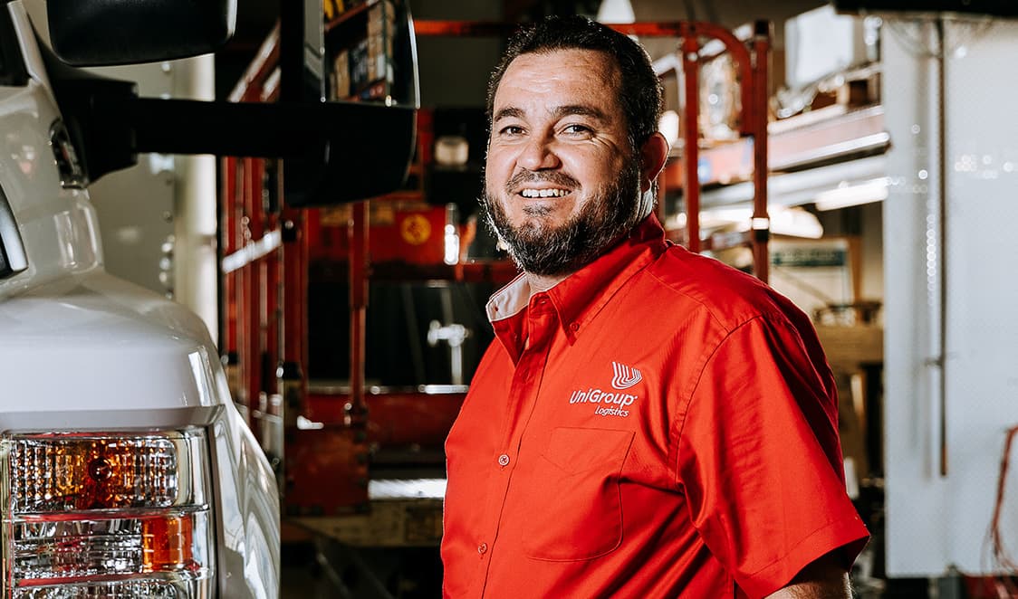 friendly team member inside truck garage